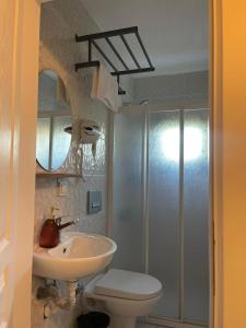 a bathroom with a sink and a toilet and a shower at Zu Tiny House Hotel & Restaurant in Urla