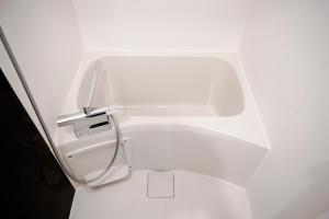 a bathroom with a white toilet in a room at #9 3mins to station 1stop to Shinjuku Stylish apartment with plenty of sunlight in Tokyo +40 photos
