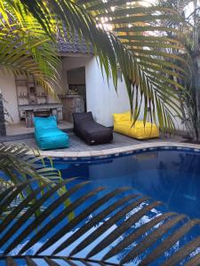 a group of pillows sitting next to a swimming pool at Mango 5 Hotel in Amed