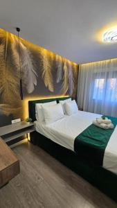 a bedroom with a bed with wings on the wall at City Center Apartment in Tirana
