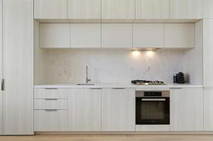 a white kitchen with white cabinets and an oven at Oakview on Main in Mornington