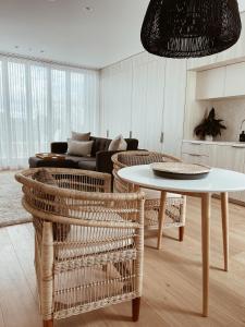 a living room with a table and chairs and a couch at Oakview on Main in Mornington