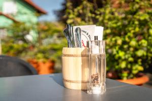 a glass container with utensils sitting on a table at Hotel Restaurant Ancho in Cölbe