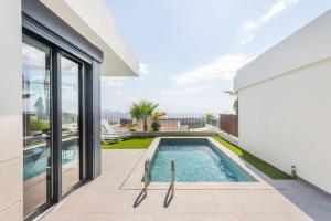 a swimming pool in the backyard of a house at Casa con piscina climatizada y vistas al mar in Polop +33 photos