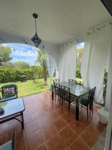 a patio with a table and chairs and a view of a yard at La Vida Villa Alcudia Smir Fnideq, Holiday Homes in Tetouan