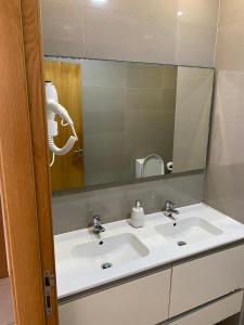 a bathroom with a sink and a mirror at Casa Berlengas a Vista in Peniche +44 photos