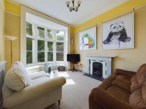 a living room with a couch and a fireplace at The Old Vicarage in Ilfracombe