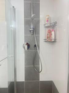 a bathroom with a shower with a glass door at Buchman Cozy 1Bedroom Haven in Modi'in-Maccabim-Re'ut