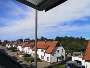 a row of houses with red roofs on a street at B&B Atuatuca in Tongeren