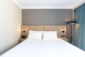 a bedroom with a large white bed with two pillows at Sandman Hotel Vancouver Downtown in Vancouver