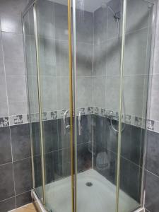 a shower with a glass door in a bathroom at SMIR PARK in Marina Smir