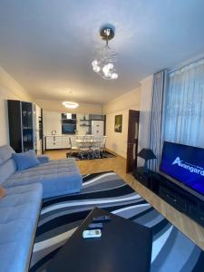 a living room with a couch and a flat screen tv at Иссык-Куль ЦО "Karven Four Seasons" таунхаус in Chon-Sary-Oy