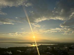 a view of the sun setting over a city at 緩慢大鵬灣 in Donggang