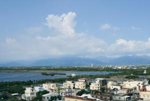 a city with buildings and a body of water at 緩慢大鵬灣 in Donggang