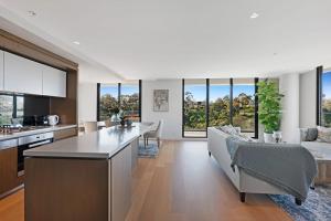 an open kitchen and living room with a couch at Luxury overlooking the Yarra - 01663 in Melbourne