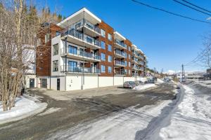 an apartment building on a street in the snow at Nice apartment close to Bardufoss Hotel - minimum 3 nights in Bardufoss