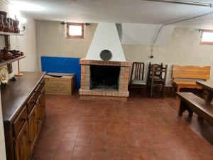 a kitchen with a brick fireplace in a room at EL COTARRO DE PESQUERA in Pesquera de Duero