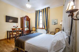 a bedroom with a bed and a desk and a table at Soggiorno Campos in Florence +28 photos
