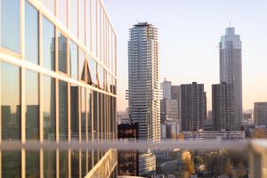 a view of a city skyline with tall buildings at Urban Residences Rotterdam in Rotterdam