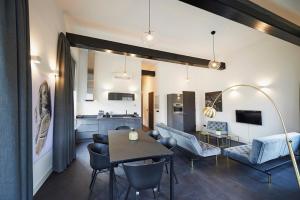 a living room with a dining table and a kitchen at "DE BANK" - Hotel Apartments in Harlingen