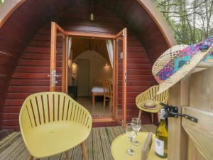 a small cabin with two chairs and a table at Pod No 5 in Keswick