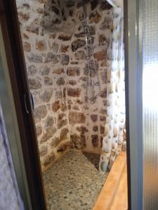 a corner of a room with a stone wall at SUNSHINE in Bríkion