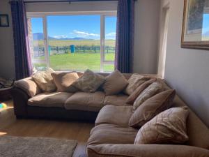 a couch in a living room with a large window at Shanadune in Tralee