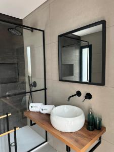 a bathroom with a sink and a mirror at Ermal Terrace in Vieira do Minho