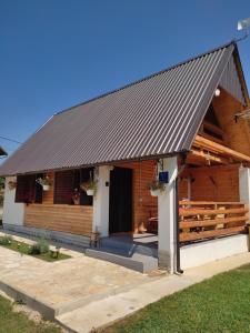 a log cabin with a black roof at Kuća za odmor Antonija in Gospić