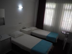 Postel nebo postele na pokoji v ubytování Soykan Hotel