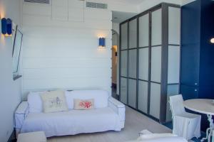 a living room with a white couch and a table at Attico Capri in Capri