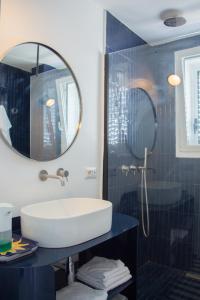 a bathroom with a sink and a mirror at Attico Capri in Capri