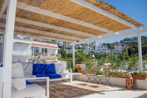 a pergola on a patio with a view of the city at Attico Capri in Capri