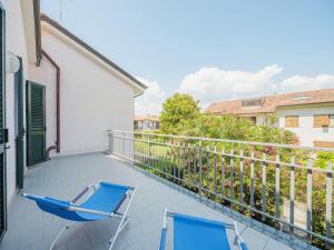 a pair of chairs on the balcony of a house at Holiday Home Lucerna Due-1 by Interhome in Ameglia