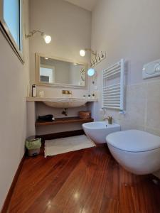 a bathroom with two white sinks and a mirror at Apulia Journey - Manzoni 11 in Bari