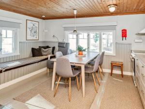a kitchen and dining room with a table and chairs at Holiday Home Punatulkku by Interhome in Hirsjärvi +40 photos