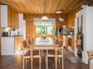 une salle à manger avec une table et des chaises dans une cuisine dans l'établissement Holiday Home Karjalan kelohuvila by Interhome, à Muurasjärvi