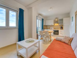 a living room with a couch and a table at Apartment Villa Tara-1 by Interhome in Brseč
