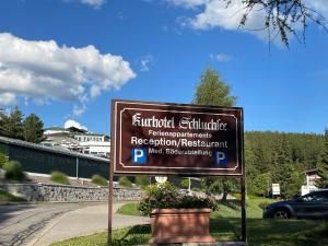 a sign in the grass next to a road at Apartment App- 1406 - Kurhotel Schluchsee by Interhome in Schluchsee