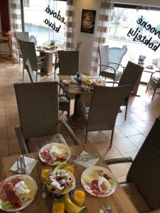 a table with plates of food on top of it at Penzion Sklář in Nový Bor