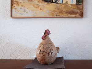 a statue of a chicken sitting on a table at Apartment Lake Placid A7 by Interhome in Nendaz