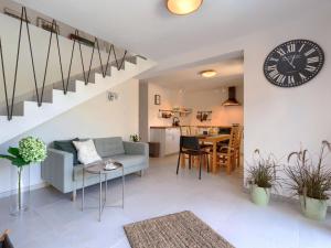 a living room with a couch and a clock on the wall at Holiday Home Klementini by Interhome in Cerovlje