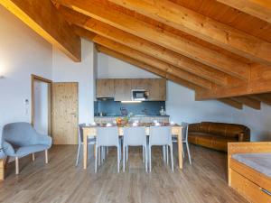 a kitchen and dining room with a table and chairs at Apartment T-Resort La Tzoumaz 4p8 vue vallée by Interhome in La Tzoumaz