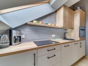a kitchen with white cabinets and a sink at Apartment Kubaczka by Interhome in Wisła