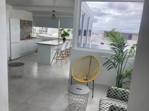 a kitchen and living room with a table and chairs at El Marinero, piso 2 y piso 3 in La Santa