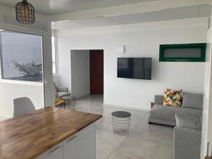 a living room with a couch and a table at El Marinero, piso 2 y piso 3 in La Santa