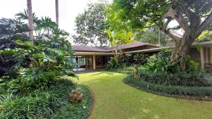 a garden in front of a house at Gana Begawan Luxury Private Villa in Payangan
