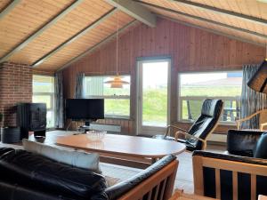 uma sala de estar com mesa e cadeiras em Holiday Home Juha - from the sea in Western Jutland by Interhome em Bjerregård