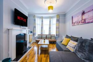 a living room with a couch and a fireplace at Finchley House by Anfield in Liverpool