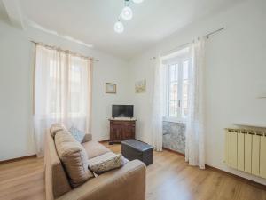 a living room with a couch and a television at Holiday Home Casa di Giò by Interhome in Marina di Massa